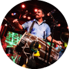 Sunny Jain smiles and plays the dhol drum