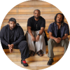 Sullivan Fortner Trio sits and poses on stairs