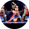 A yamato performer plays two large drums that are being held by two more yamato performers