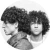 Person on left shows their side profile while person on right looks straight