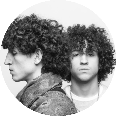 Person on left shows their side profile while person on right looks straight