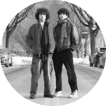 Zohar & Adam pose standing in a road and looking straight